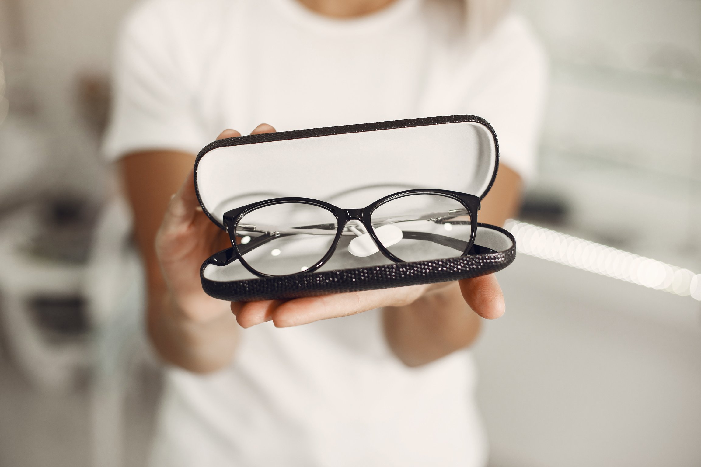 Woman Holding Case with Glasses at Optics Store